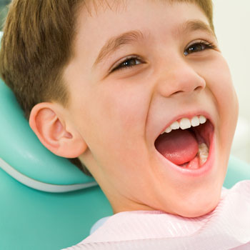 Kid model opening his mouth for a dental exam